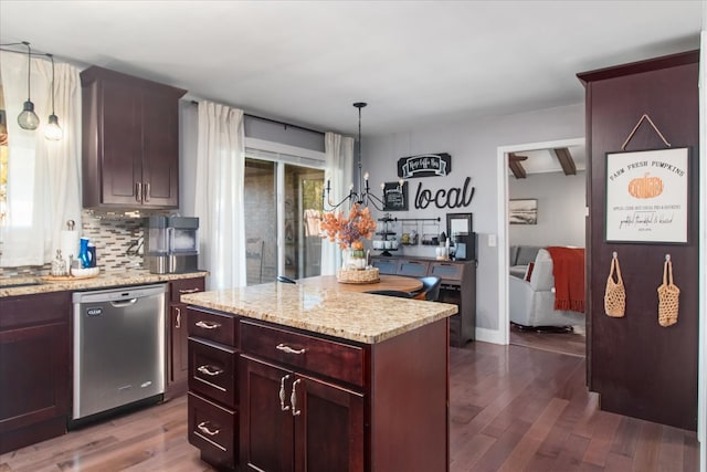 kitchen with a kitchen island, dishwasher, decorative light fixtures, and dark hardwood / wood-style flooring