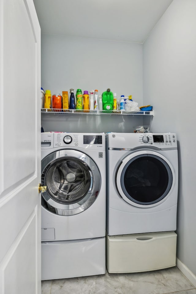 clothes washing area featuring washing machine and clothes dryer