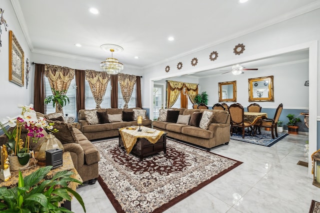 living room with a healthy amount of sunlight, ornamental molding, and ceiling fan with notable chandelier