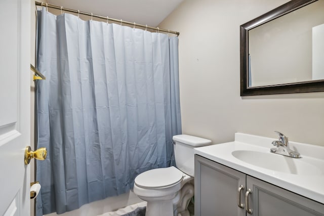 bathroom featuring vanity, a shower with shower curtain, and toilet