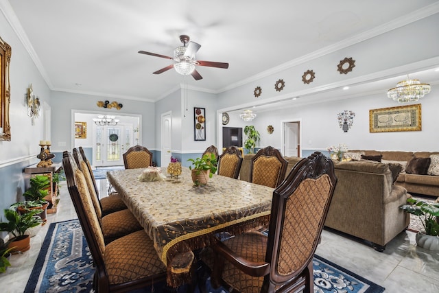 dining room with crown molding and ceiling fan with notable chandelier