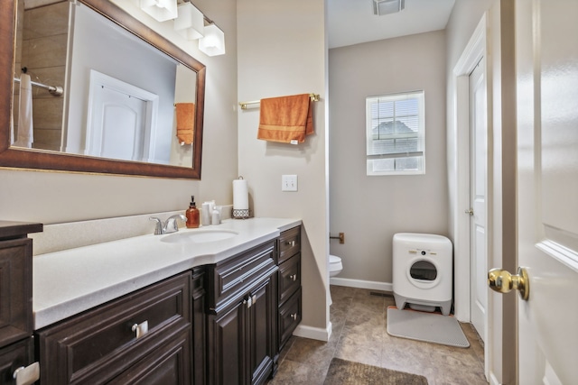 bathroom featuring vanity, toilet, and tile patterned flooring