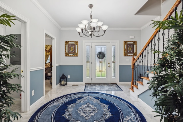 foyer entrance featuring crown molding and a notable chandelier