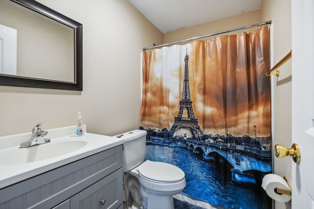 bathroom featuring vanity, a shower with curtain, and toilet