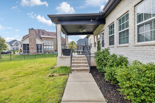 view of yard featuring a porch and ceiling fan