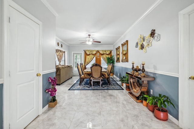 dining room with ceiling fan and ornamental molding