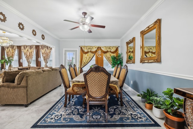 dining area with crown molding, ceiling fan with notable chandelier, and plenty of natural light