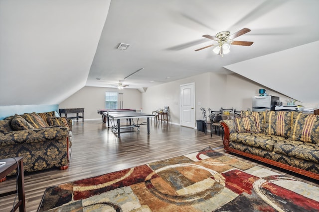 living room featuring ceiling fan, vaulted ceiling, and hardwood / wood-style floors