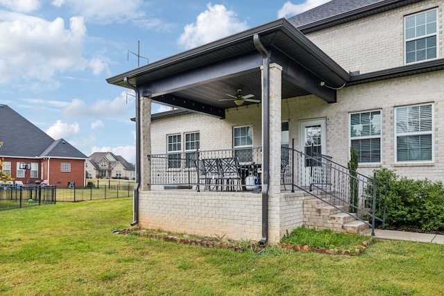 exterior space with a patio area, a yard, and ceiling fan