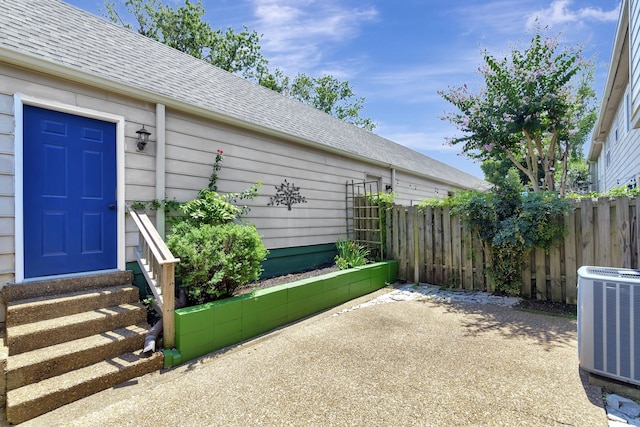 entrance to property featuring cooling unit