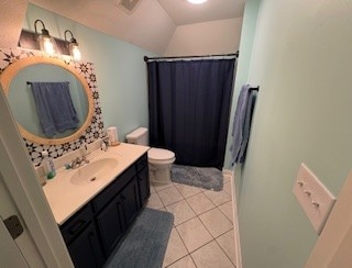 bathroom with tile patterned flooring, curtained shower, vanity, and toilet