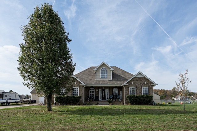 view of front of property with a porch and a front lawn