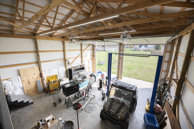 garage featuring a garage door opener and a yard