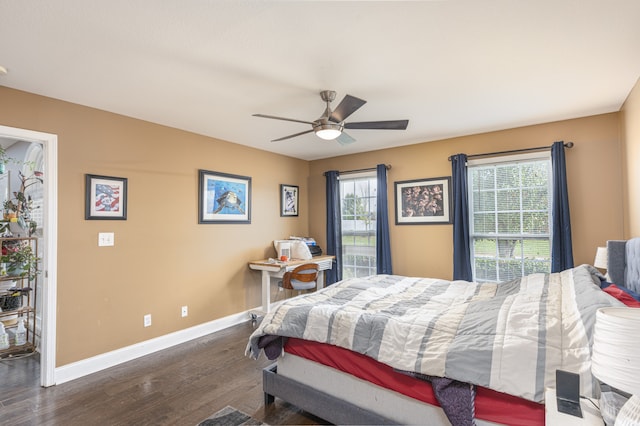 bedroom featuring dark wood-type flooring, ceiling fan, and multiple windows