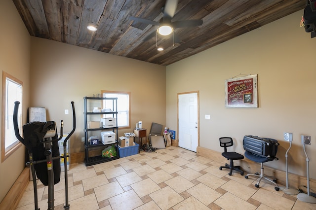 misc room with a wealth of natural light, ceiling fan, and wooden ceiling