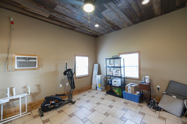 exercise room with an AC wall unit, ceiling fan, and wood ceiling