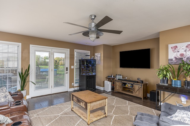 living room with ceiling fan and dark hardwood / wood-style flooring