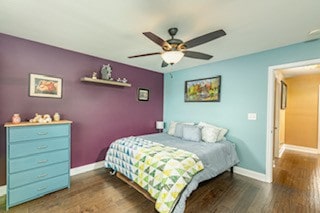 bedroom featuring ceiling fan and dark hardwood / wood-style floors