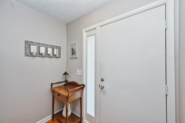 foyer with a textured ceiling