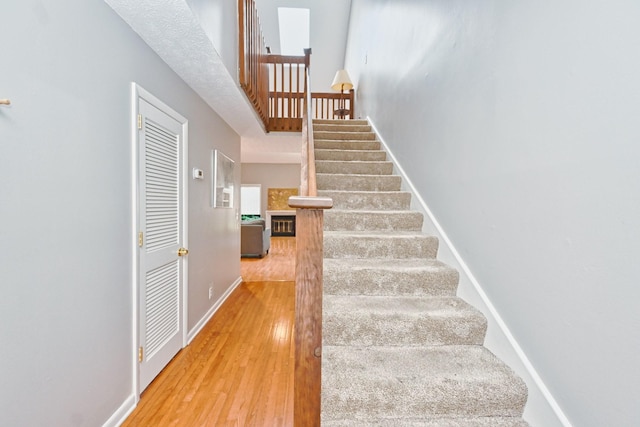 stairs featuring hardwood / wood-style floors