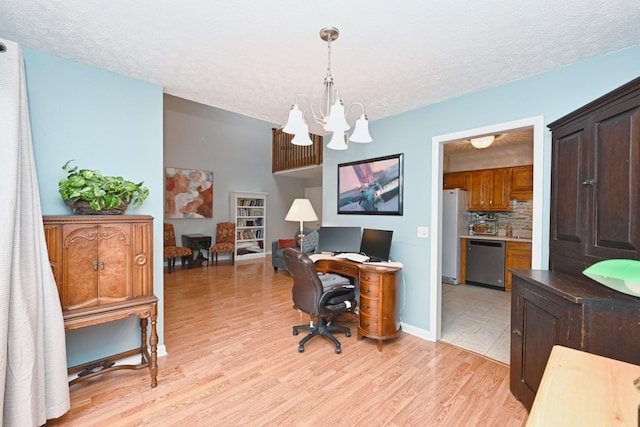 office area featuring light hardwood / wood-style floors, a textured ceiling, and an inviting chandelier