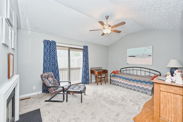 carpeted bedroom with a textured ceiling, access to exterior, ceiling fan, and vaulted ceiling