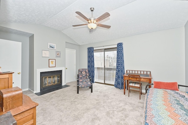 carpeted bedroom featuring ceiling fan, access to exterior, lofted ceiling, and a textured ceiling