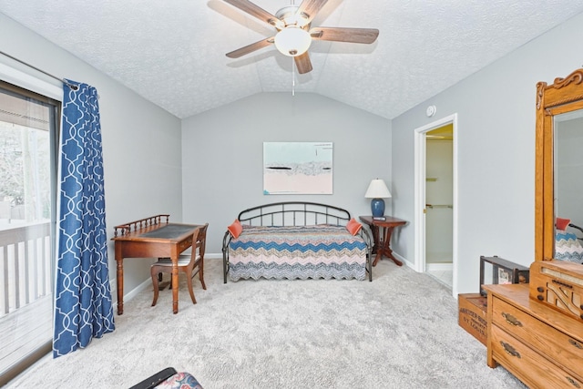 carpeted bedroom featuring a textured ceiling, ceiling fan, and lofted ceiling