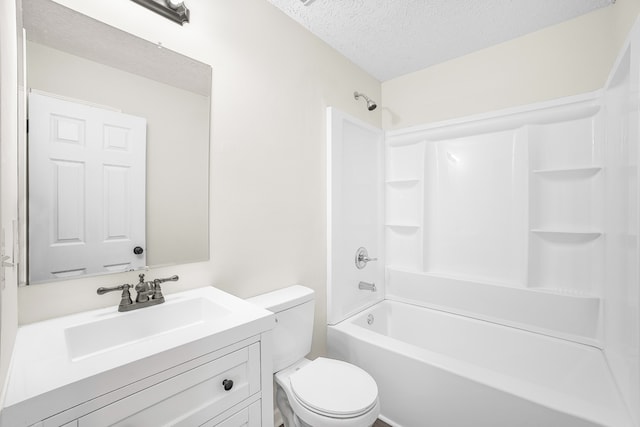 full bathroom featuring toilet, shower / washtub combination, a textured ceiling, and vanity