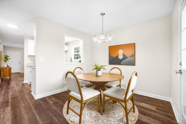 dining space with an inviting chandelier and dark hardwood / wood-style floors