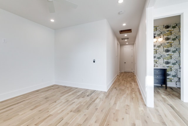 unfurnished room with ceiling fan and light hardwood / wood-style floors