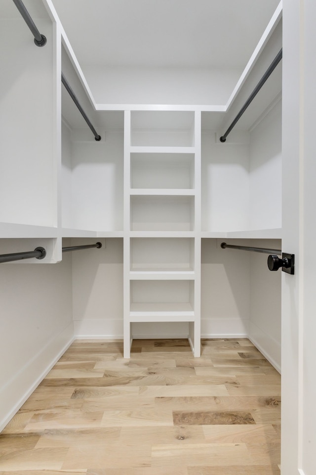 spacious closet featuring hardwood / wood-style flooring