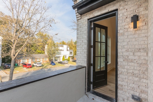 view of exterior entry featuring a balcony