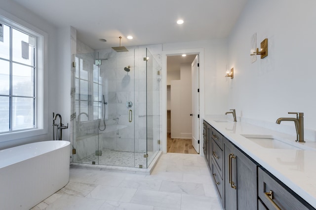 bathroom featuring vanity and independent shower and bath