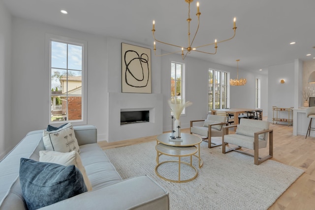 living room with a chandelier and light hardwood / wood-style flooring