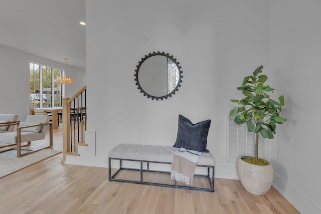 sitting room featuring a chandelier and light wood-type flooring