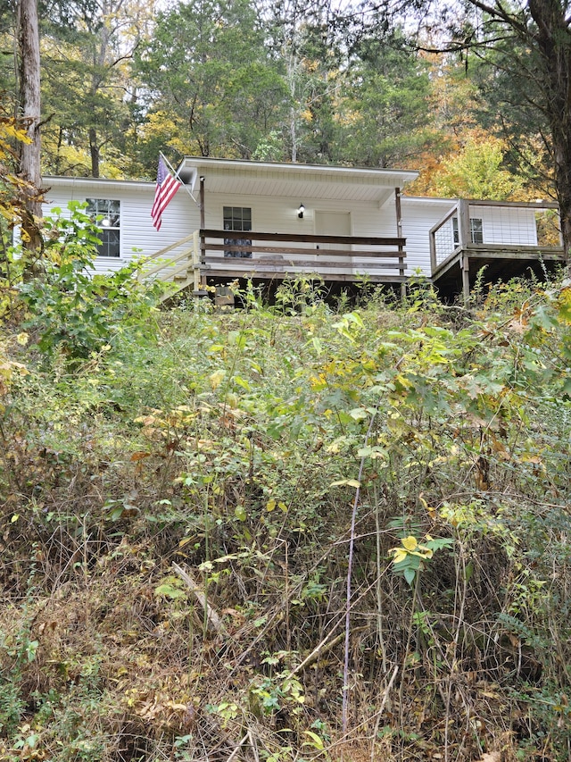 back of property featuring a wooden deck