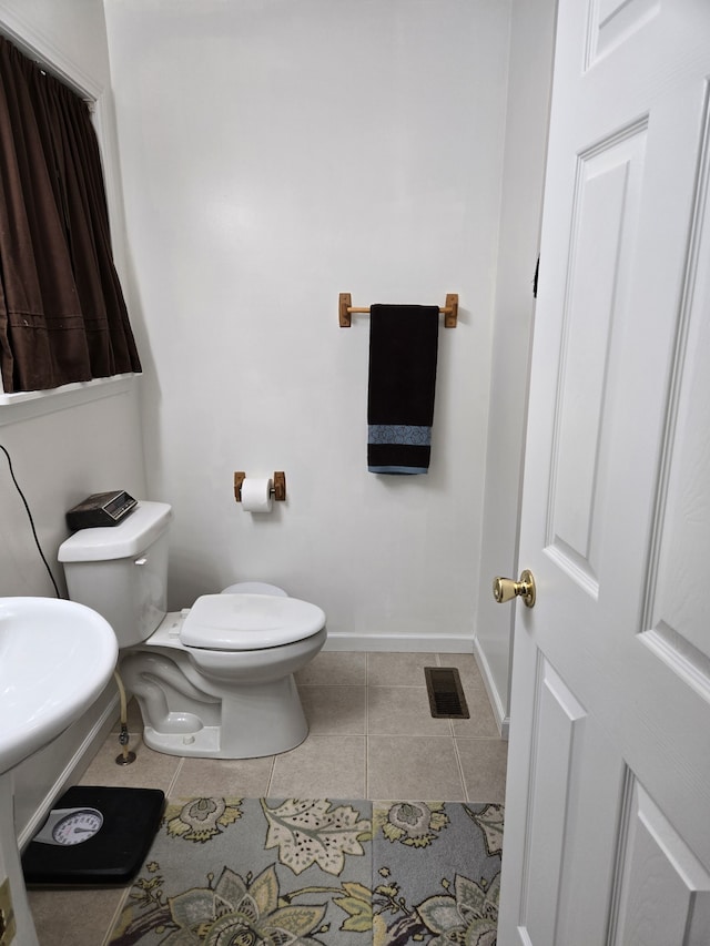 bathroom with tile patterned floors and toilet