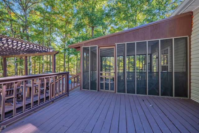 wooden deck with a pergola and a sunroom