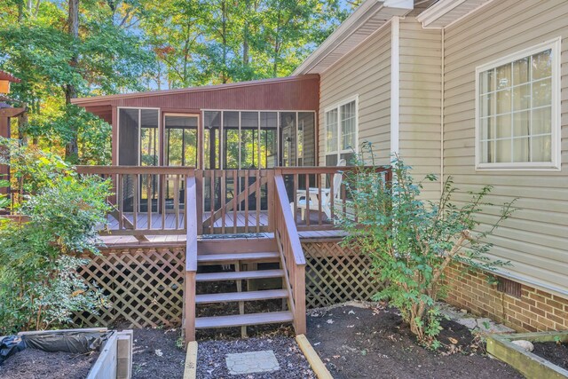 wooden deck with a sunroom