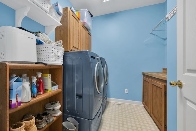 laundry area with cabinets and washing machine and dryer