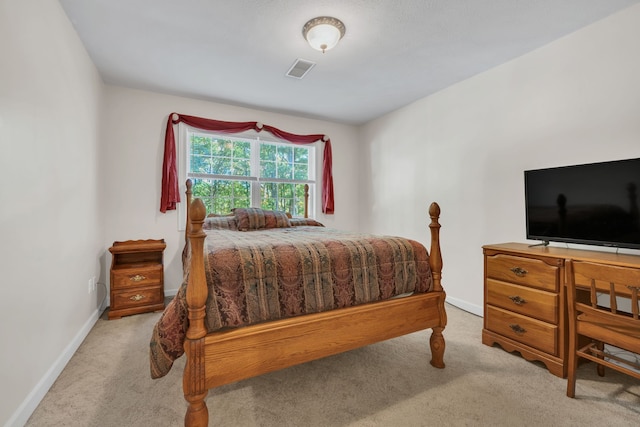 bedroom featuring light carpet