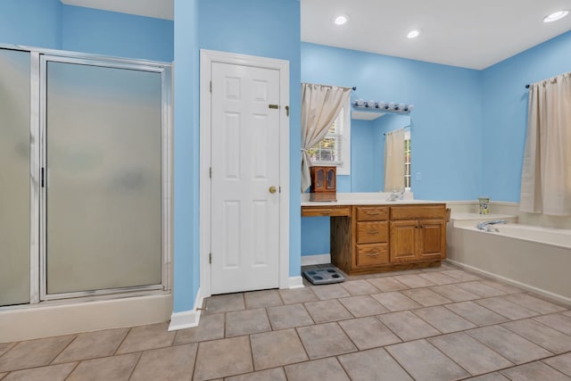 bathroom featuring shower with separate bathtub, vanity, and tile patterned floors