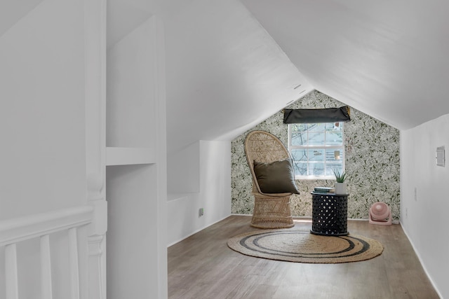 unfurnished room featuring wood-type flooring and vaulted ceiling