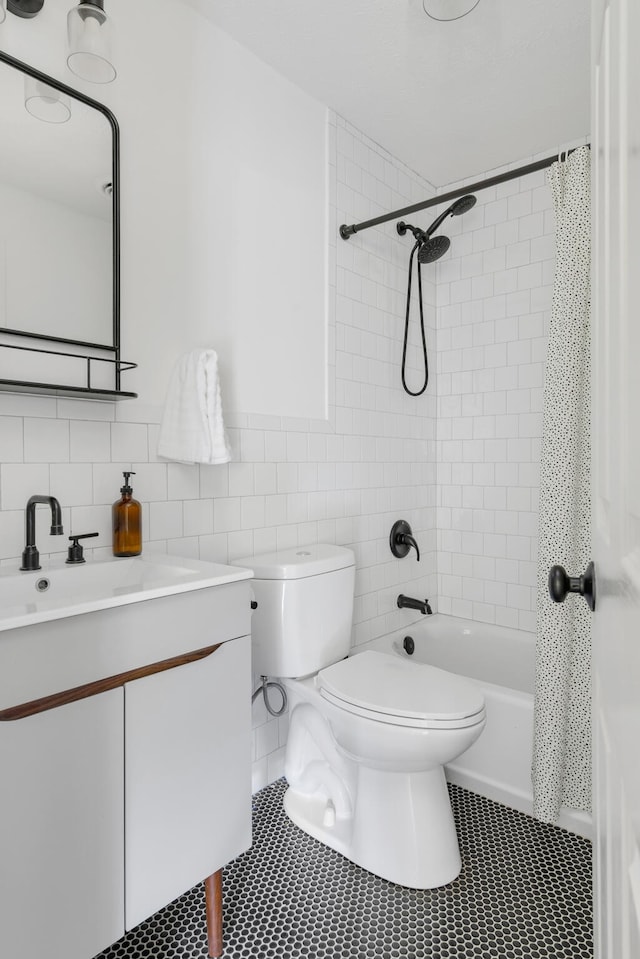 full bathroom with vanity, tile walls, and toilet