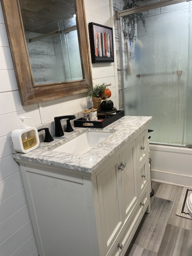 bathroom featuring vanity, walk in shower, and backsplash