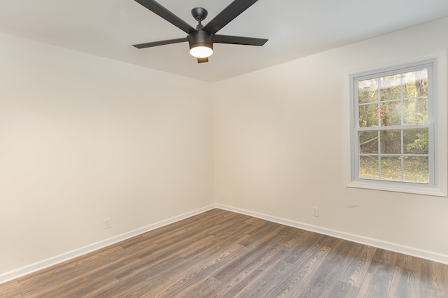 spare room featuring ceiling fan, plenty of natural light, and dark hardwood / wood-style flooring