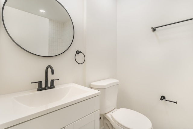 bathroom featuring vanity and toilet