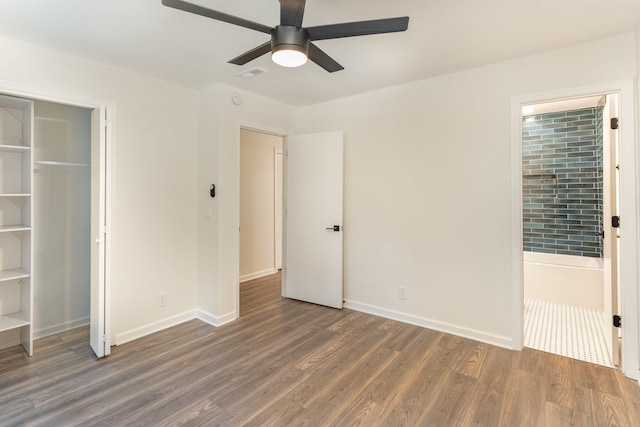 unfurnished bedroom with dark hardwood / wood-style floors, a closet, and ceiling fan