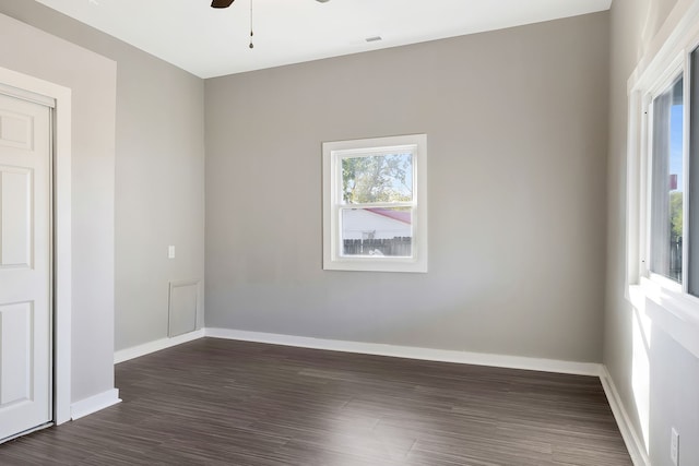 empty room featuring ceiling fan and dark hardwood / wood-style flooring